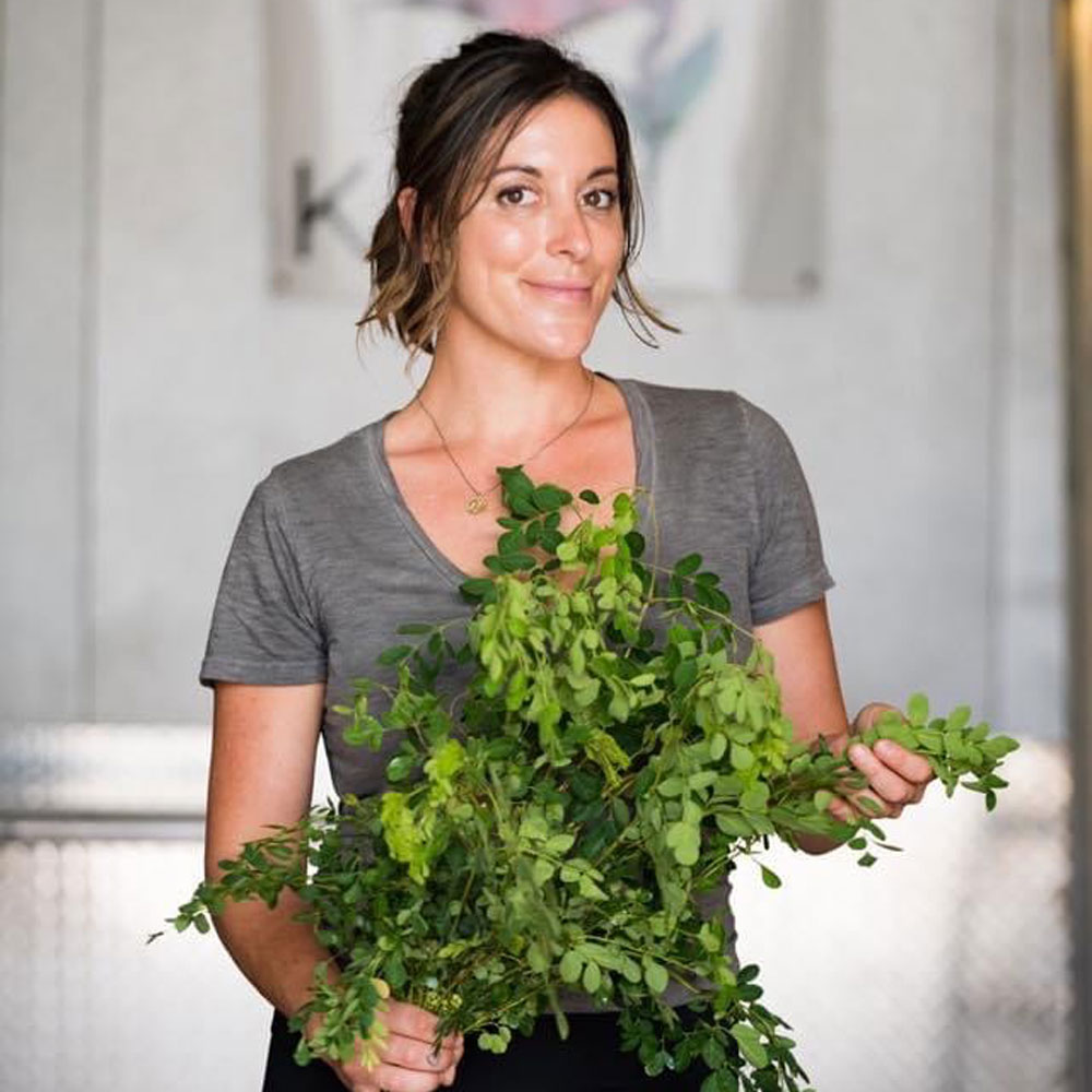 Kristal Muhich holding fresh leafy vegetables