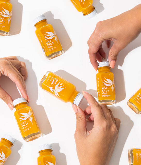 hands holding bottles of elixirs