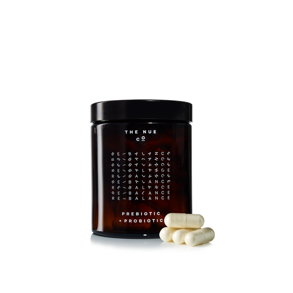 amber jar of The Nue Co. Prebiotic and Probiotic pills