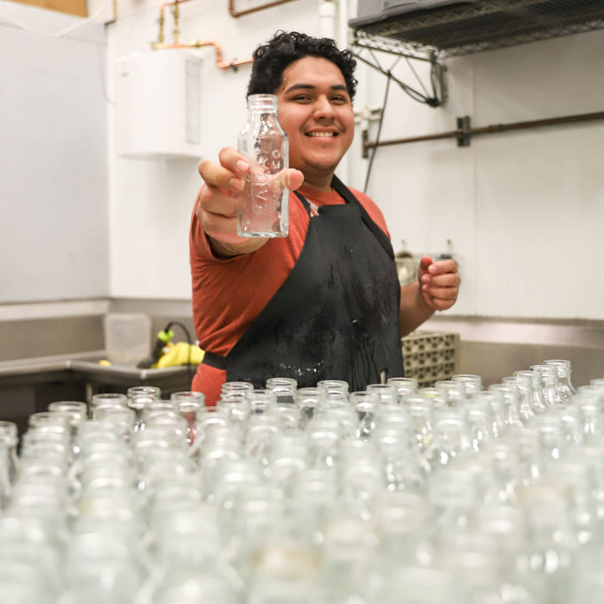 Man holding empty bottle in recycling plant