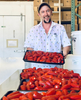 man with chili peppers on trays