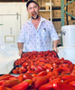 man with chili peppers on trays