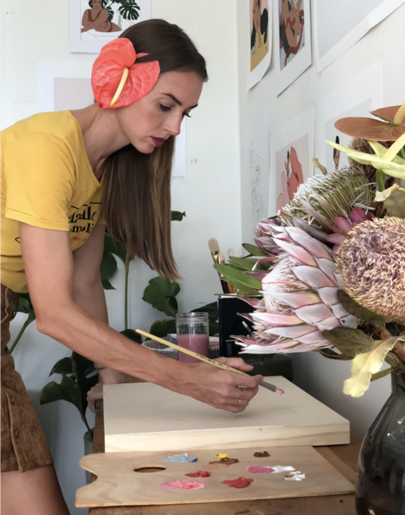 woman painting with tropical flowers