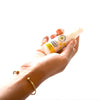 woman holding spray bottle of Beekeeper's Naturals Propolis Throat Spray dietary supplement