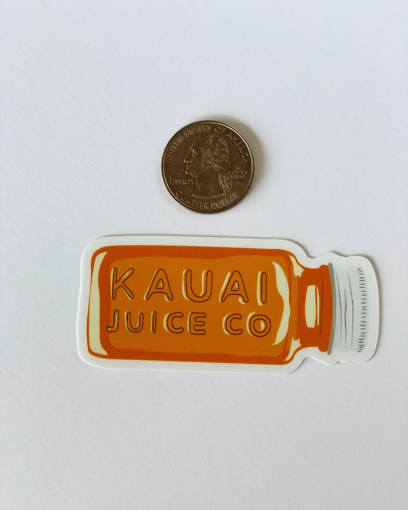hand drawn orange Kauai Juice Co. bottle with quarter for scale