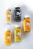 5 scattered jars of Kauai Juice Co Elixirs